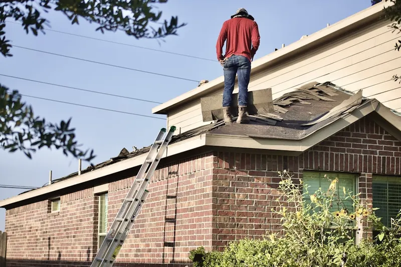 Professional roofer working on a residential roof in Moister Tract